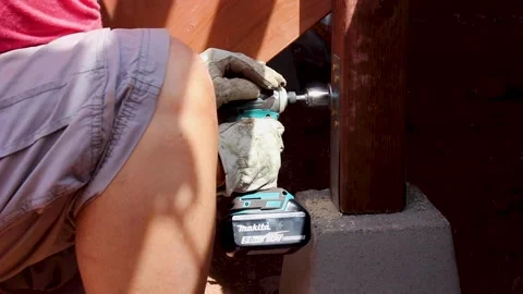 Man using power drill in wooden support beam Stock Footage 235398300