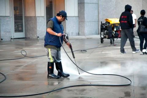 Man using pressure washer Stock Photos