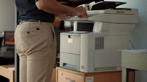 Man Using Printer Or Scanner In Office.Businessman Printing Document Stock Footage 132243495