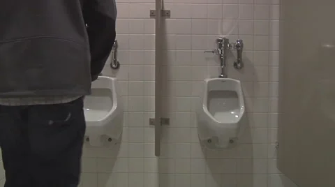 Man using a public bathroom Stock Footage 49863235