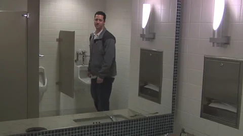 Man using a public bathroom, washing his hands and walking away Stock Footage 49863227