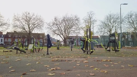 Man using a public outdoor gym at Ducketts Common in Haringey. Video stock 120141277