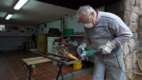 Man using a radial saw tool to file a piece of metal in his workshop. radial  Video stock 146602558