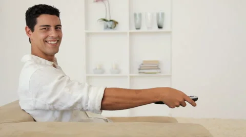 Man Using Remote Control To Change TV Channel Stock Footage 921497