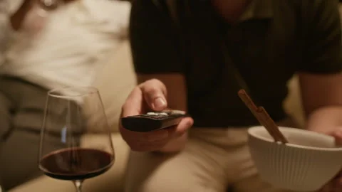 Man Using Remote Controller and Holding Bowl Stock Footage 331789365