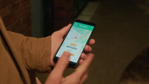 Man Using Ride Sharing Mobile App on Smartphone to Accept Trip Request Stock Footage 342016811