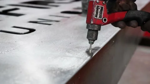 Man is using rivet gun and nails as he works with metal Stock-Footage 134163286