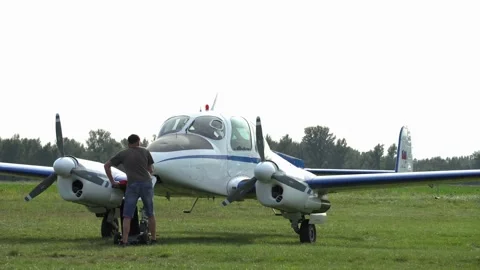 A man using rollator parking a small air-plane on the airfield Stock Footage 140269236