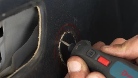 Man using a rotary tool to cut car door card. Stock Footage 344364819