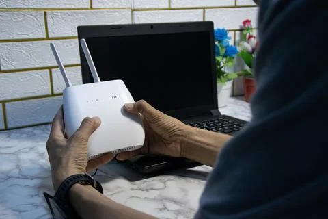 The man is using a router, high-speed internet connection, network bandwidt.. Stock Photos