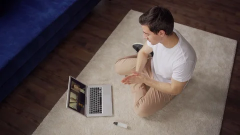 Man using sanitizer during video call from home Video stock 128761361