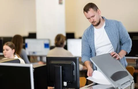 Man using scanner in computer class in school Stock Photos