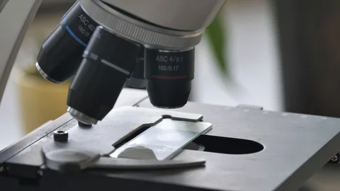 Man Using Scientific Microscope In Laboratory, CoronaVirus Cure Research Stock Footage 127701620