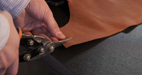 Man Using Scissors Cut Leather Sheet, Craftsman Creates Product with his Hands Stock Footage 133008057