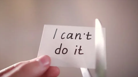 Man using scissors to remove the word can't to read I can do it concept for self Stock Footage 66679953