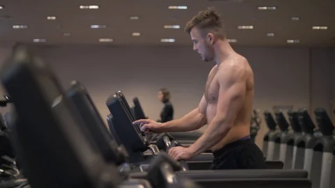 Man using screen treadmill for configuring program cardio exercise and running Stock Footage 88174814