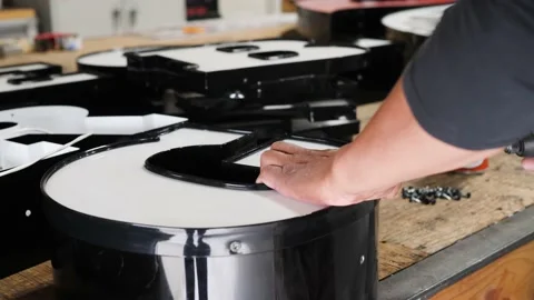 Man is using screwdriver as he works with signage 스톡 동영상 135276312