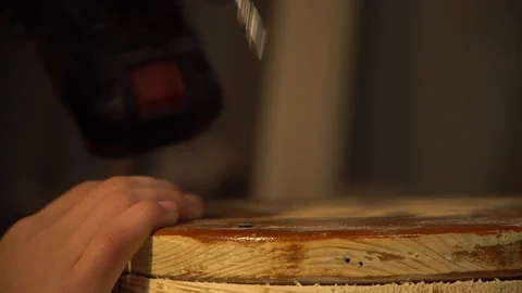 Man using a screwdriver to remove screws from a wooden board Video stock 125859354
