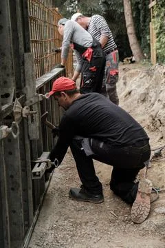 Man using screwdriver while working with wooden materials on construction site Foto stock