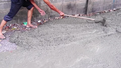 A man using a shovel with cement to fix the road. Stock Footage 171763071