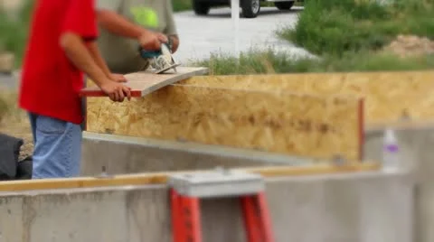 Man using skill saw building a house Stock Footage 11408830