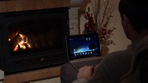 Man Is Using Skype On A Laptop In Front Of A Fireplace Communication Concept Stock Footage 44015387