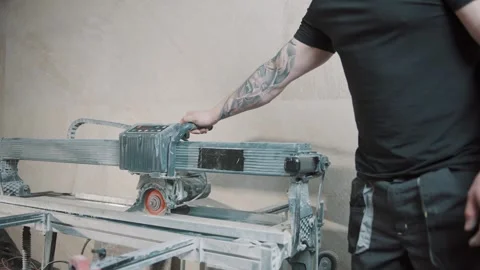 Man using slow motion tile cutting tool in construction project indoors Video stock 307040593