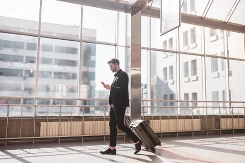 Man using the smarphone for finding the right gate Stock Photos