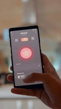 Man using smart home app touching screen to turn on light by phone Фото