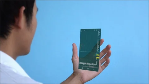 A man using smart phone for analyze stock market.hologram graph stock with futur Video stock 100576094
