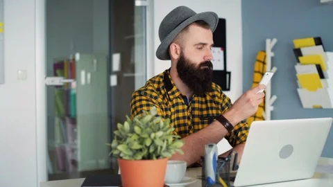 Man using a smart phone and a computer  Stock Footage 86683421