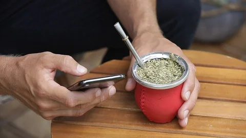 Man using smart phone and drinking yerba mate tea Stock Footage 127796548