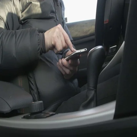 Man using a smart phone in a car Stock Footage 69406920