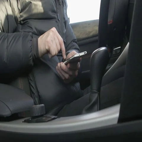 Man using a smart phone in a car Stock Footage 69407542
