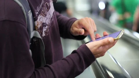 Man using smart phone on escalator Stock Footage 108615043