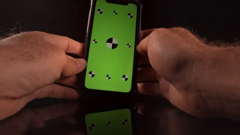 Man using a smart phone with green screen and tracking markers Stock-Footage 125290212