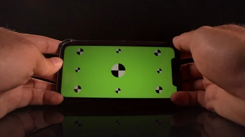 Man using a smart phone with green screen and tracking markers Stock-Footage 125290236