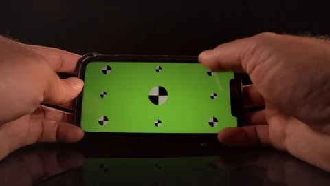 Man using a smart phone with green screen and tracking markers Stock Footage 125290255