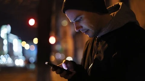Man using smart phone mobile night city lights background scrolling tapping Stock Footage 83735937