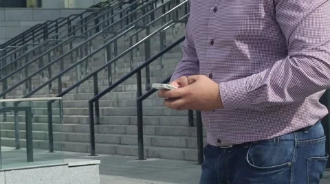 Man is using smart phone near his work Stock Footage 55534756