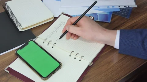 Man using smart phone in office space, sitting on chair and using green screen Stock Footage 189372370