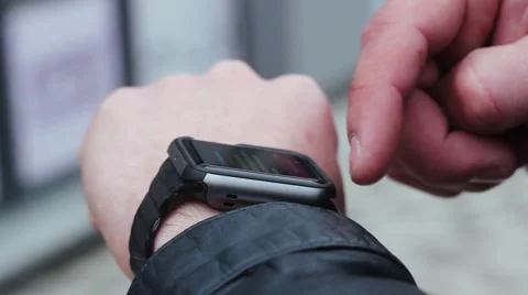 Man Using Smart Watches. he Stands Near the Business Center on the Street. Stock-Footage 61179447