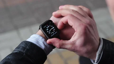 Man Using Smart Watches. he Opens the Menu and Touching a Finger to the Screen. Stock-Footage 61179546