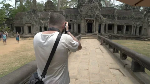 Man using smartphone and camera while doing photos of old ruins  Video stock 102050625