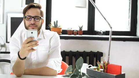 Man using smartphone and chatting, rest in office Stock Footage 86158421