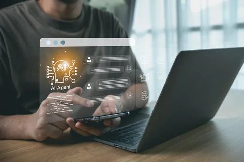Man using smartphone and laptop with futuristic AI agent chatbot interface .. Stock Photos