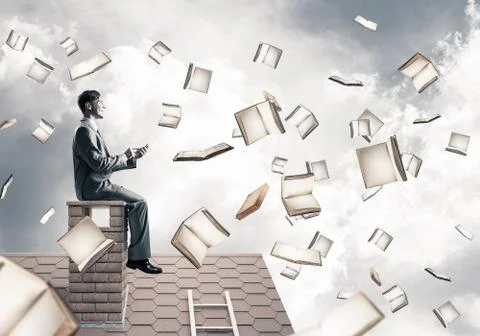 Man using smartphone and many books flying in air Stock Photos