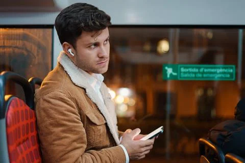 Man using smartphone and riding bus Stock Photos