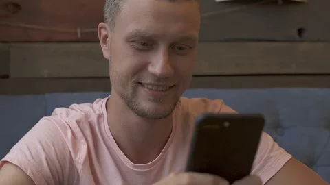 Man using smartphone and smiling. Stock Footage 95218161