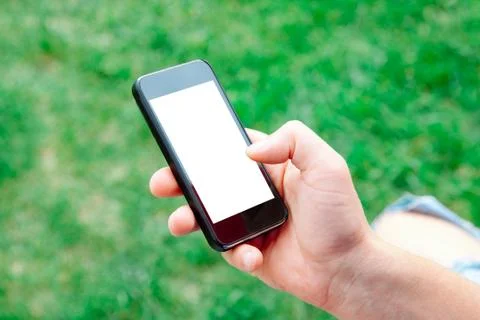 Man using smartphone with blank screen outdoors, closeup. Mock up for design Stock Photos